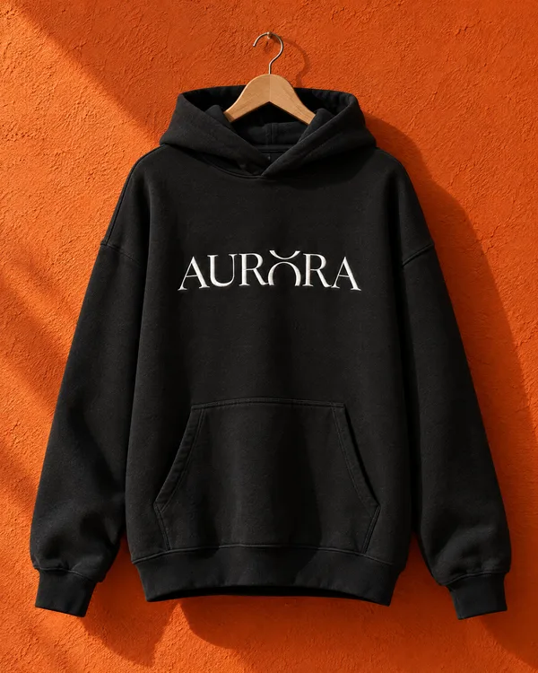 A black Aurora hoodie on an orange wall