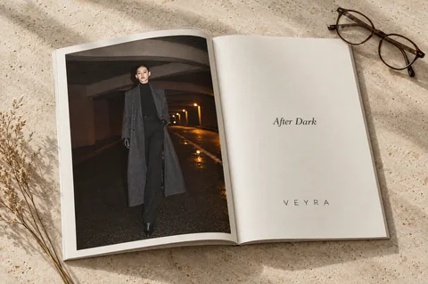 VEYRA lookbook open on a travertine table, the After Dark page