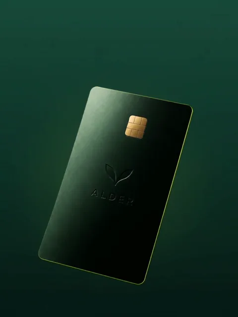 The matte forest-green ALDER card turning slowly on green